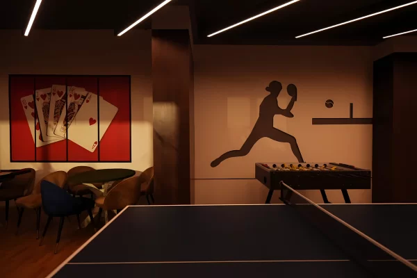 An interior shot of the game room, featuring a table tennis setup and foosball (a facility within the clubhouse) at Infinity Heights near the Luxury Apartments in Guwahati.