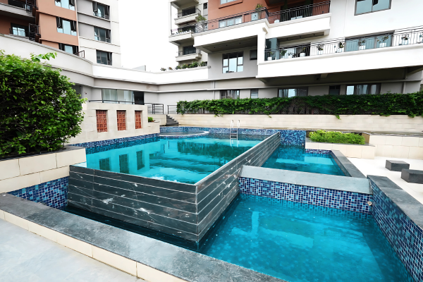 A stylish, multi-level swimming pool amenity (part of the clubhouse) available to residents of the Luxury Apartments at Infinity Heights in Guwahati.