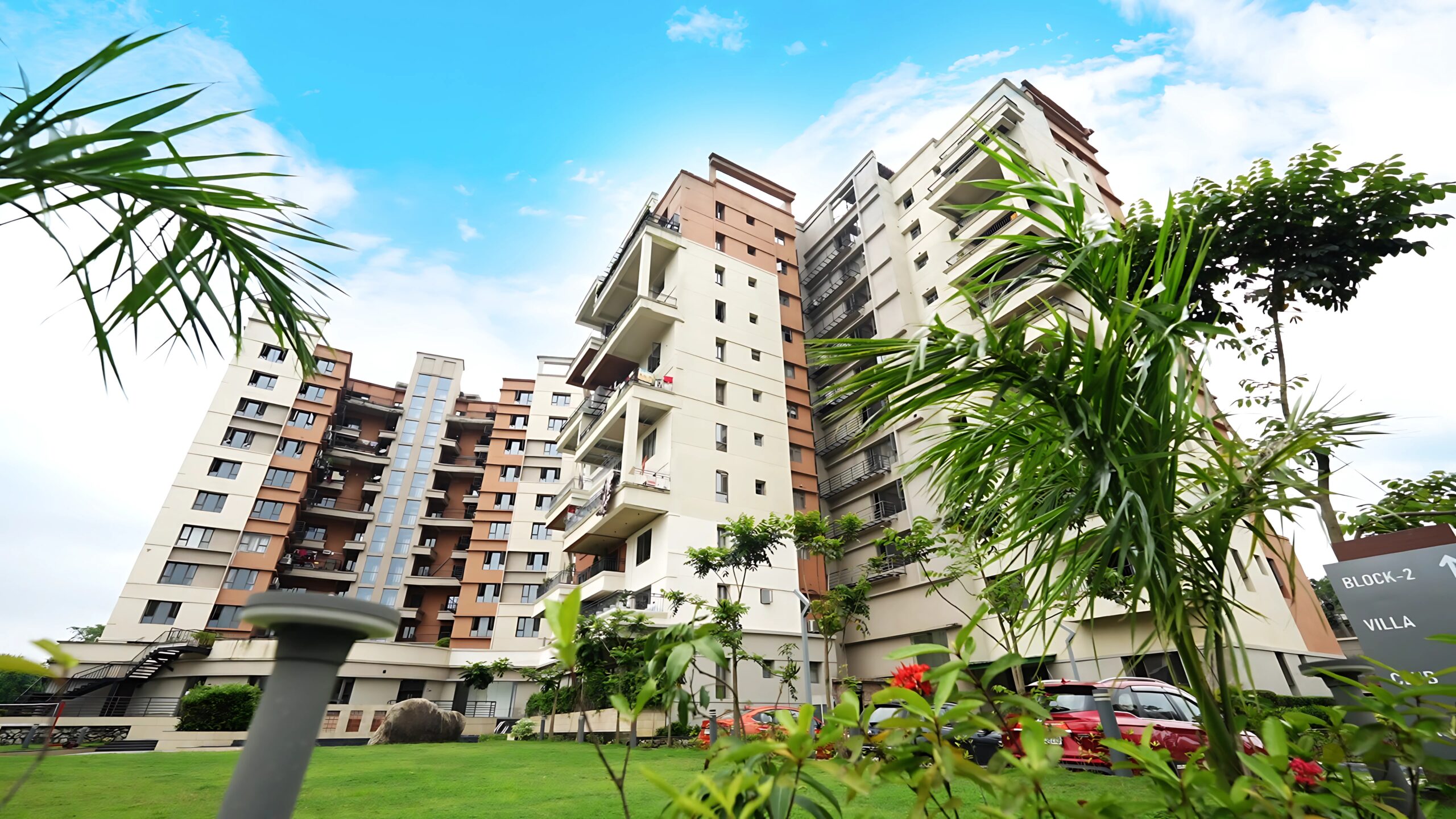 Lush, landscaped gardens embrace the stunning modern architecture, creating a serene sanctuary within the city. This harmonious blend of nature and sophisticated design is the hallmark of our luxury apartments in Guwahati, offering residents a truly refreshing and upscale living experience.