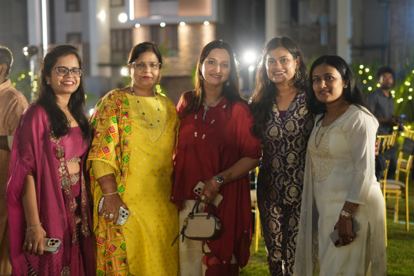 Guests at Infinity Heights' 'Parivaar Ke Sitaare' pre-Diwali celebration. Five women in festive attire smile for a photo at the outdoor event, showcasing the vibrant community life at these apartments in guwahati.