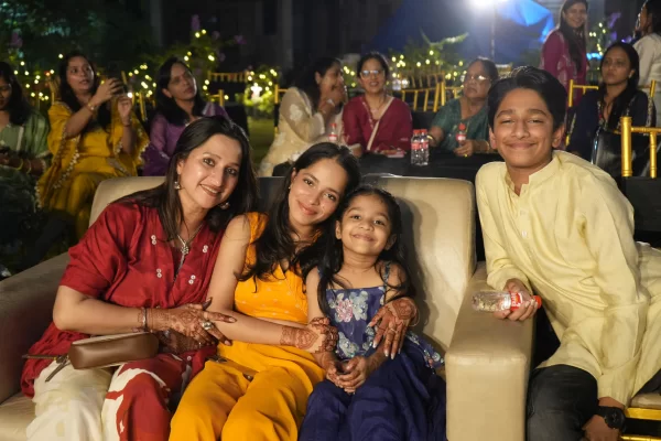 A family smiles for a photo while seated at the Infinity Heights 'Parivaar Ke Sitaare' pre-Diwali celebration. This event highlights the family-friendly community perfect for those looking for 3 bhk flats in guwahati.