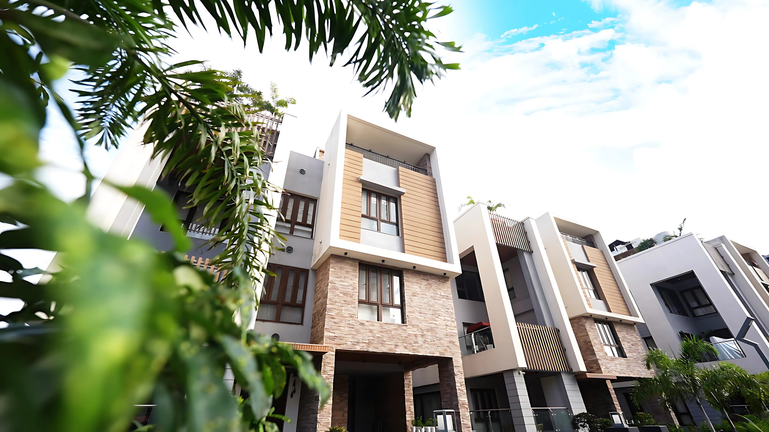 Exterior View Experience the pinnacle of luxury living at Infinity Heights, where modern architecture meets serene landscapes. This stunning exterior view highlights our premium design and secure, gated environment, offering a resort-like atmosphere atop Kalapahar. Unlike standard flats in Guwahati, our community provides an elevated lifestyle complete with wide driveways and access to a state-of-the-art Clubhouse. It is the perfect sanctuary for families seeking peace, prestige, and a connection to nature.