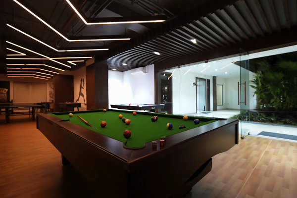 Modern game room featuring a pool table at Infinity Heights, an exclusive amenity for residents of our 4 bhk luxury apartments.