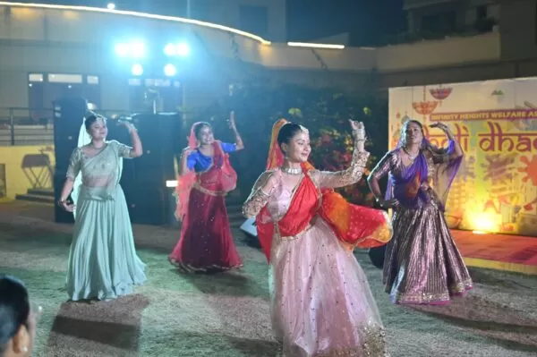 Vibrant 2026 Holi Dhamal at Infinity Heights Guwahati, featuring traditional dance and residents in ethnic wear near a luxury villa for sale in guwahati, celebrating community on the garden lawn.