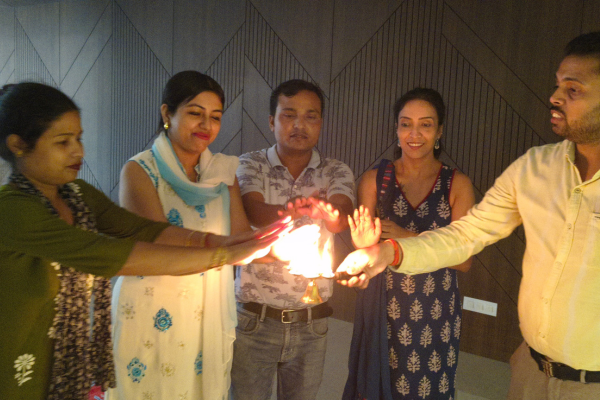 Residents performing a traditional aarti ritual during the celebration at an Apartment in Guwahati.