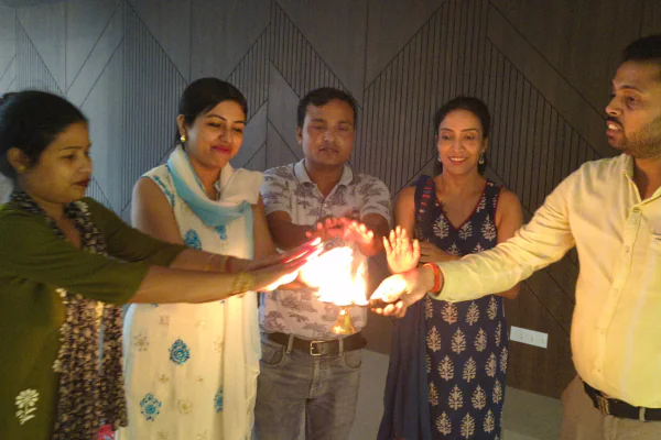 Residents performing a traditional aarti ritual during the celebration at an Apartment in Guwahati.