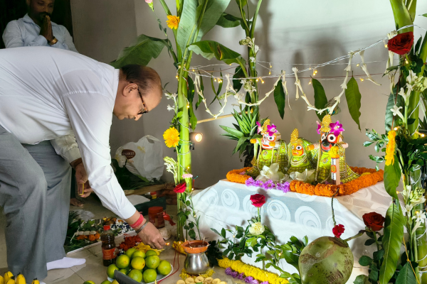 Resident offering prayers and lighting lamps at the deity altar inside an Apartment in Guwahati.