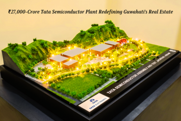 A detailed architectural scale model of the Tata semiconductor plant Assam in Jagiroad, illustrating the sprawling industrial facility nestled against green hills with simulated glowing lights.
