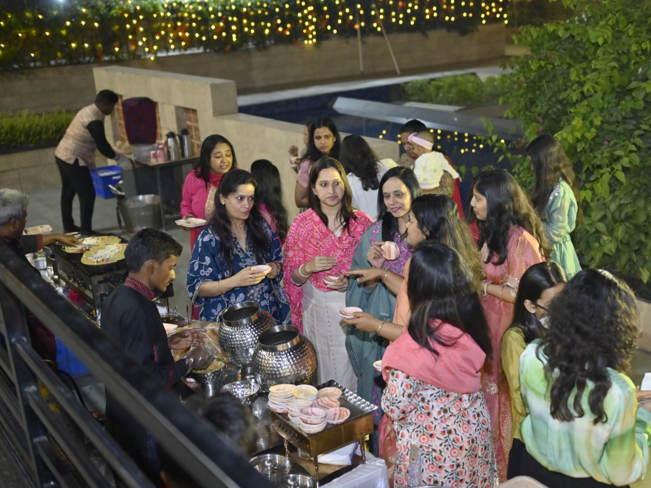 Residents enjoying festive food and community dining during the Holi celebrations at Infinity Heights, a luxury apartment in Guwahati.