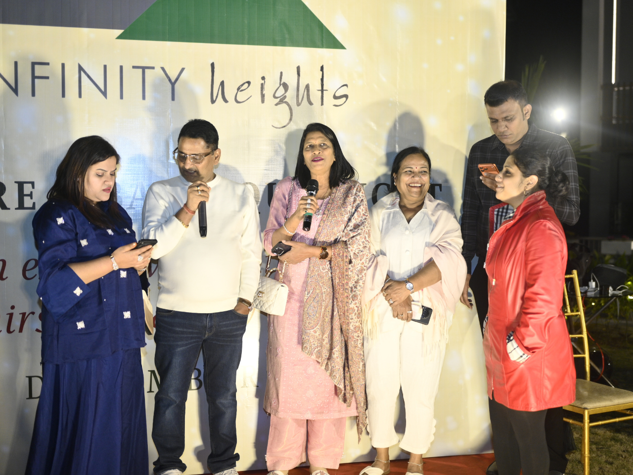 Residents sharing festive greetings on stage during the pre-Christmas event at Infinity Heights, a premier apartment in Guwahati.