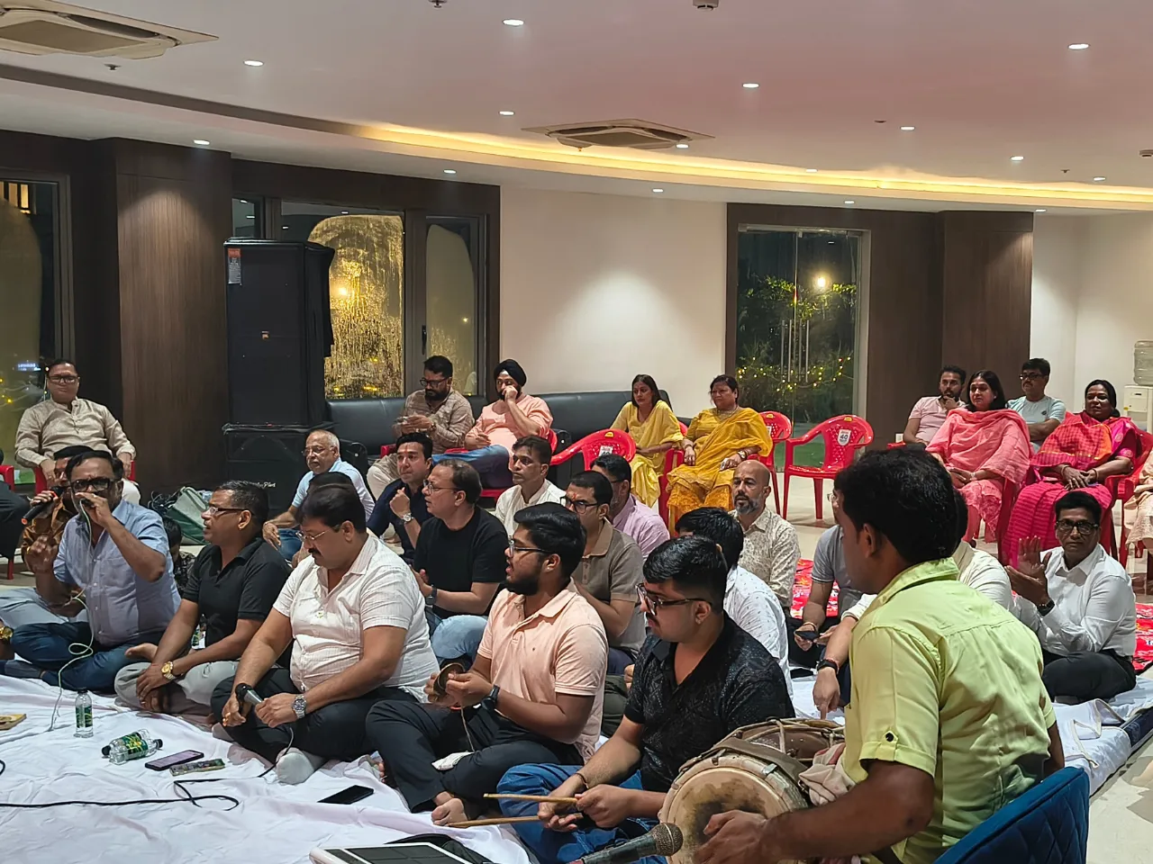Residents playing dholak and singing devotional hymns during the evening Kirtan at Infinity Heights apartment in Guwahati