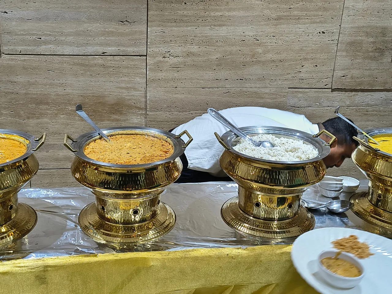 Warm dinner buffet and prasadam arrangement during the community celebration at Infinity Heights apartment in Guwahati