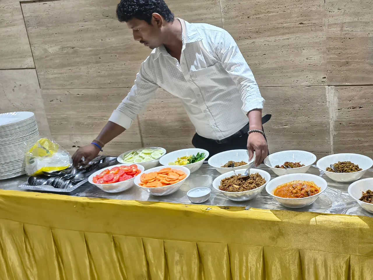Catering team setting up fresh food counters for residents at Infinity Heights apartment in Guwahati