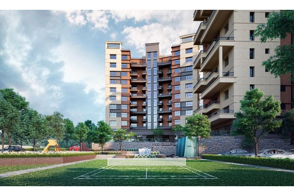 Modern residential building with landscaped surroundings showcasing flats for sale in Guwahati.