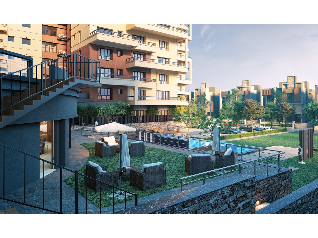 Modern apartment complex with landscaped courtyard, outdoor seating, and swimming pool.