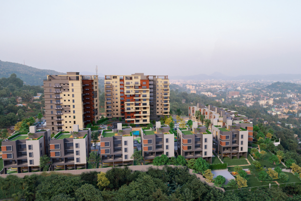 Aerial view of luxury apartments in Guwahati surrounded by lush green hills and a scenic cityscape.